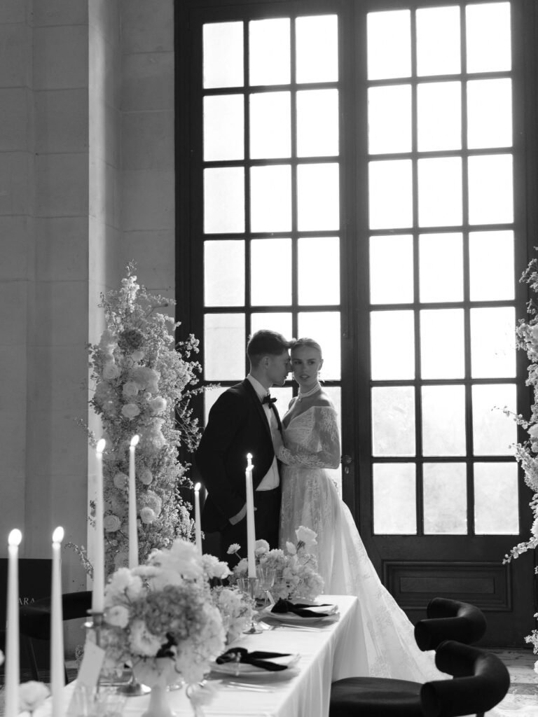 Timeless moment: Black and white photo of a couple embraced amidst floral beauty